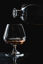 Close-Up Shot of an Alcoholic Drink Poured into a Snifter Glass