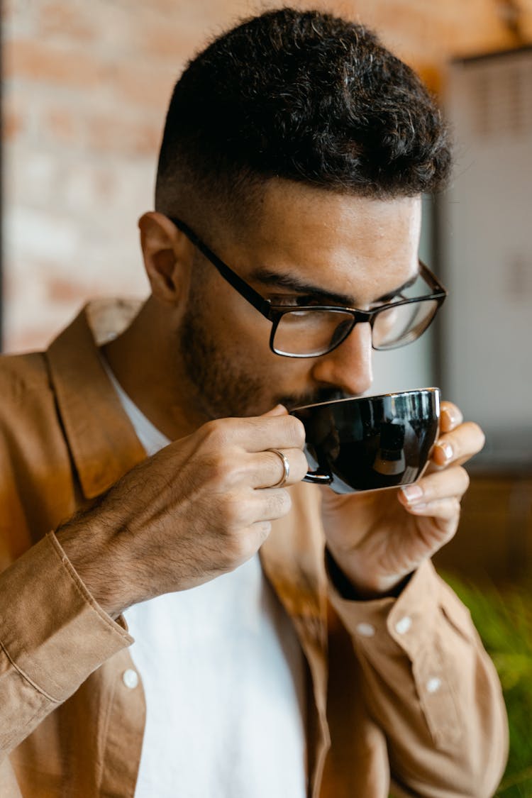 A In Brown Long Sleeves Drinking Coffee