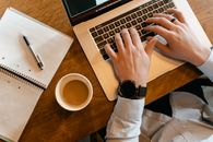 Person in White Long Sleeve Shirt Holding White Ceramic Mug With Coffee