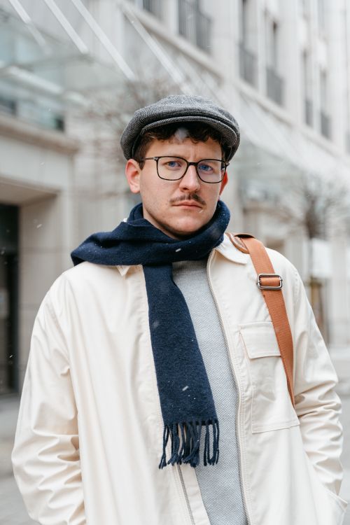 Free Portrait of a stylish man with glasses and scarf outdoors in wintertime. Stock Photo