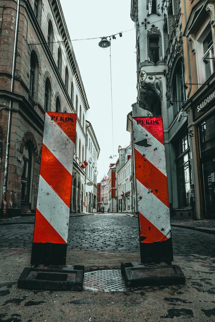 Warning Signs Near Hatch On City Street