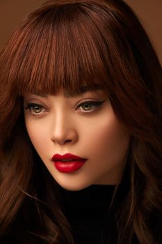 Close-up portrait of a woman with flawless red lips and bangs. Captivating look.