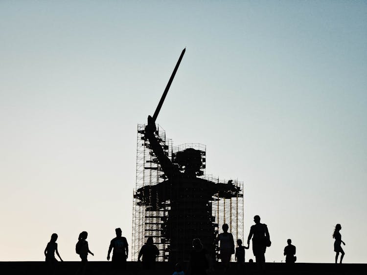 People By Statue In Construction