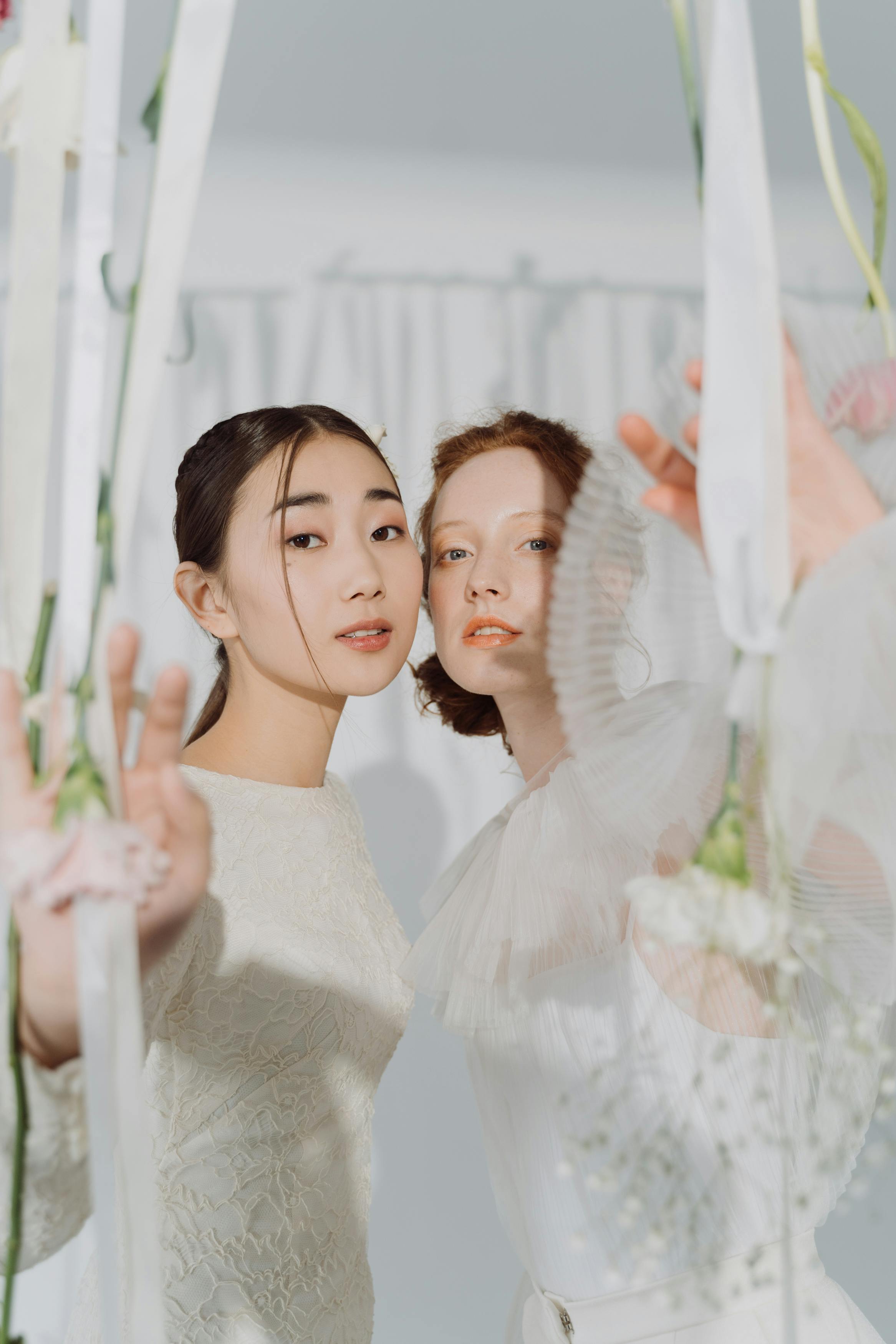 a same sex couple wearing white dress