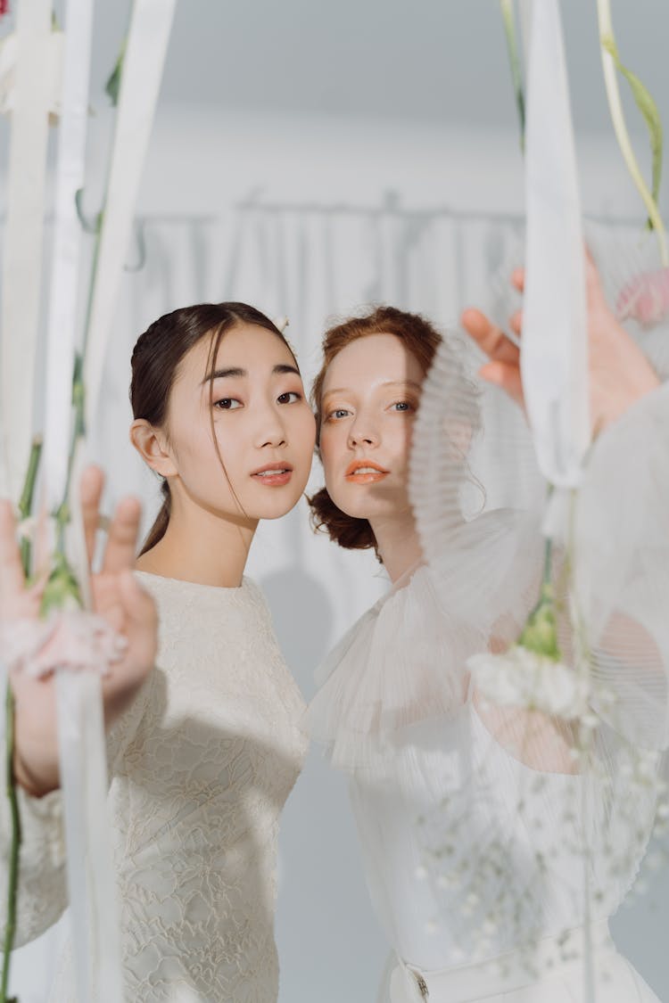 A Same Sex Couple Wearing White Dress