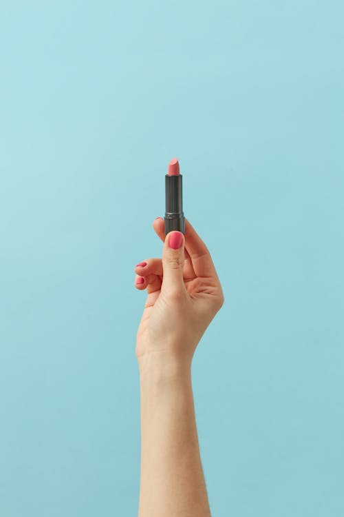 Person Holding a Pink Lipstick