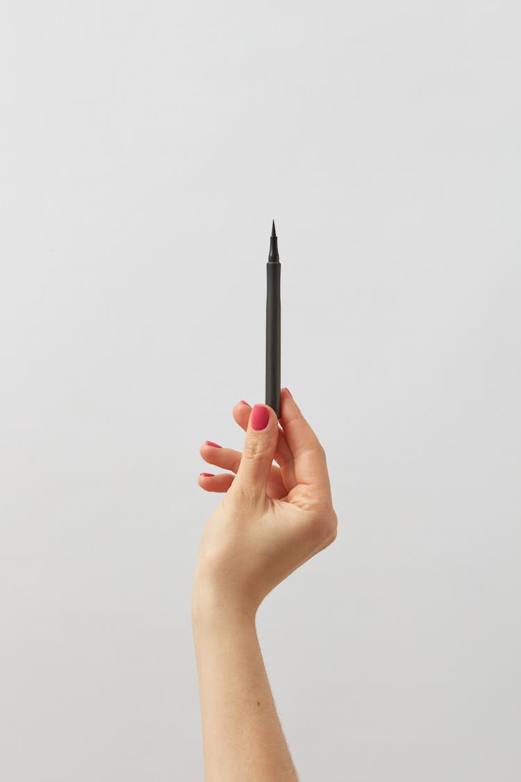 Hand Holding Eyeliner Pencil 