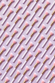 Vibrant makeup brushes arranged on a pastel surface, perfect for beauty and fashion themes.