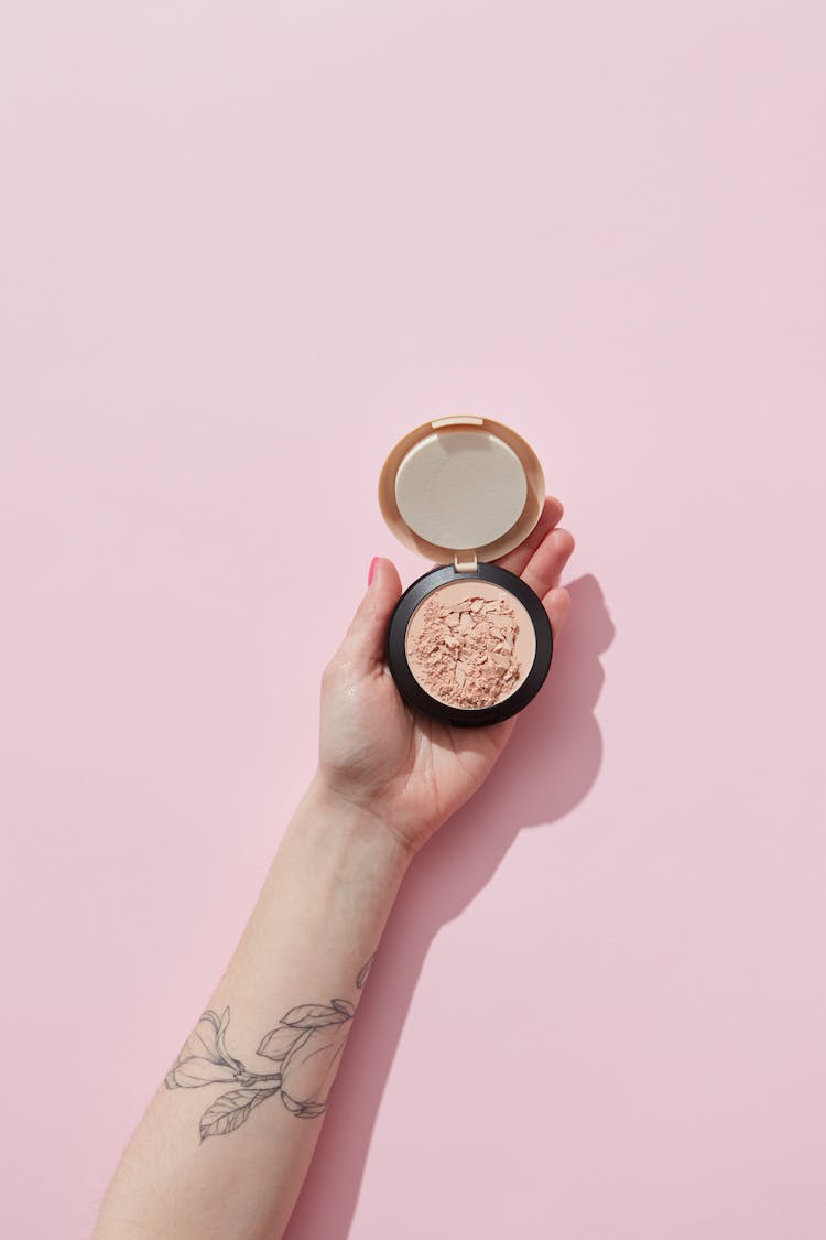 Broken Face Powder On A Person's Hand