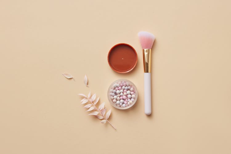 Cosmetic Product On Round Container And A Makeup Brush