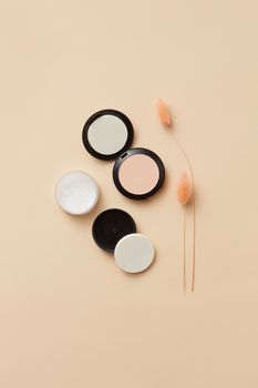 Top view of beauty products with neutral background and subtle decor.