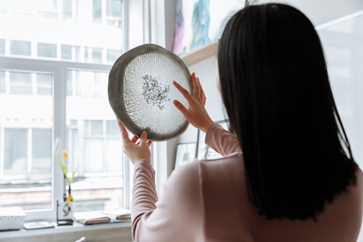 Woman Holding Up Her Resin Art Project