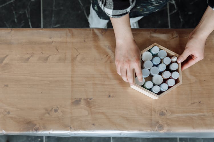 Paint Bottles On A Wooden Hexagon Box