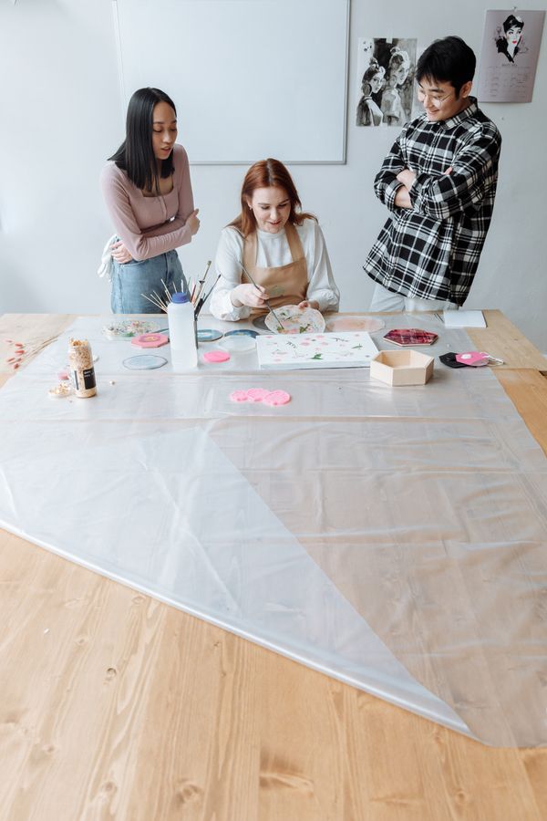 An art instructor working with students in a studio — photo by Thirdman on Pexels