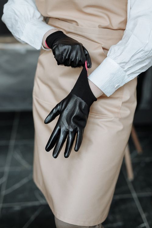 Free A person wearing black gloves in a close-up shot, adjusting them for a perfect fit. Stock Photo