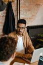 Man in Brown Jacket Sitting on Chair