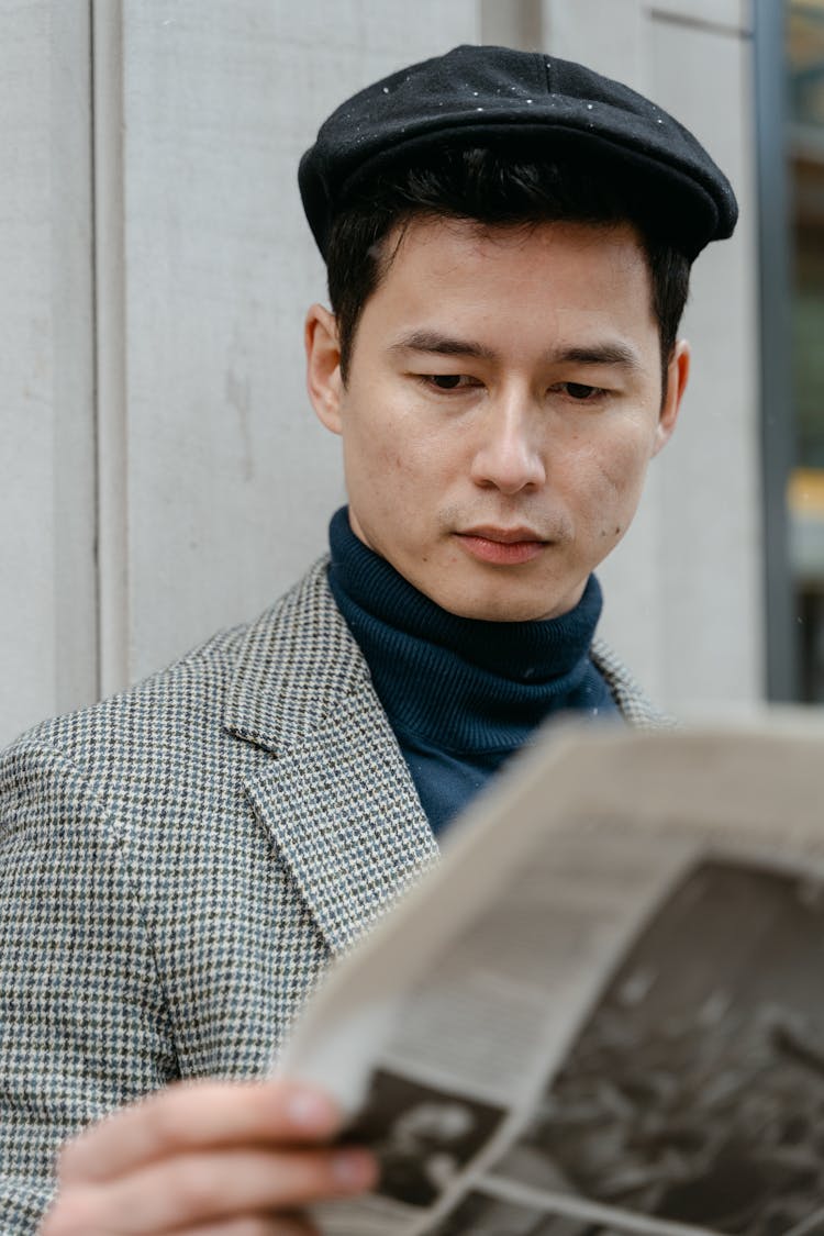 A  Man Reading A Newspaper