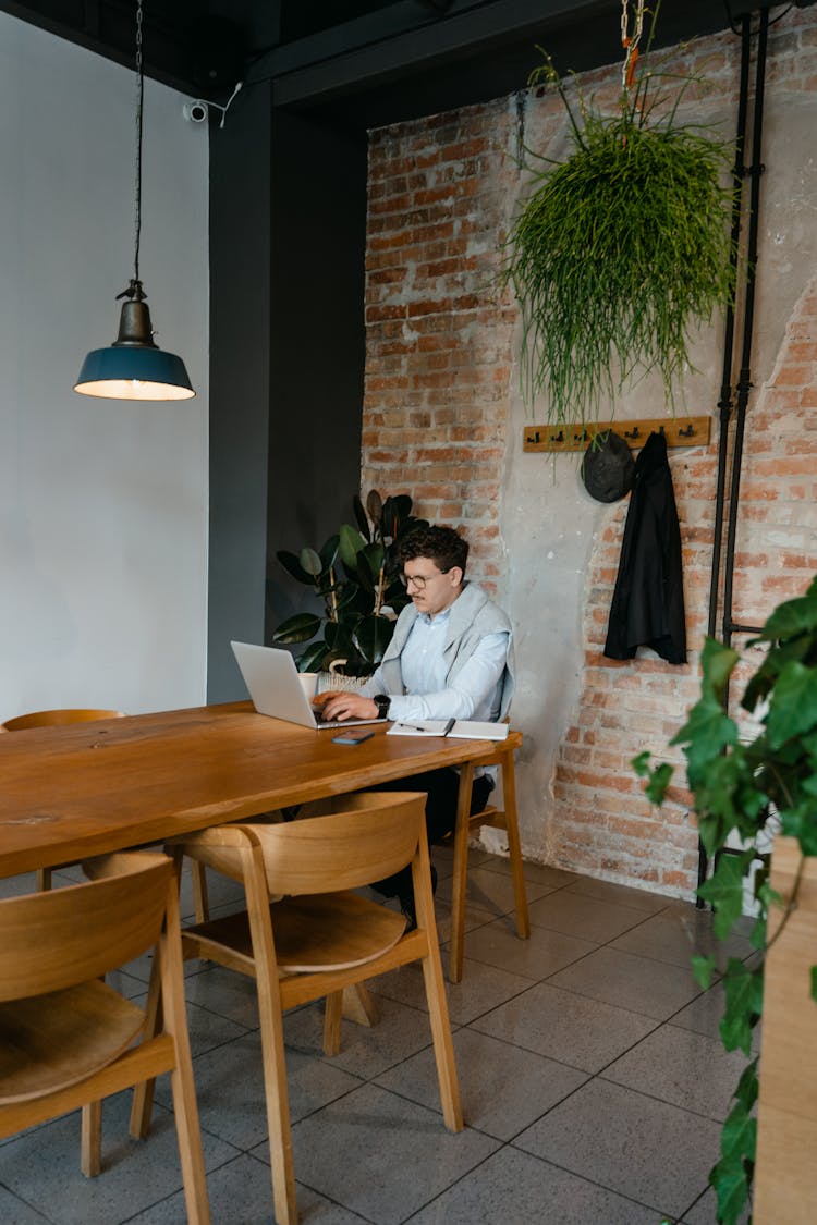 A Man Working On A Laptop