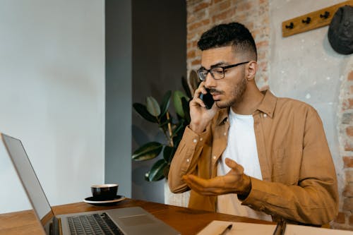 Free A Man in Brown Long Sleeves Having a Phone Call Stock Photo