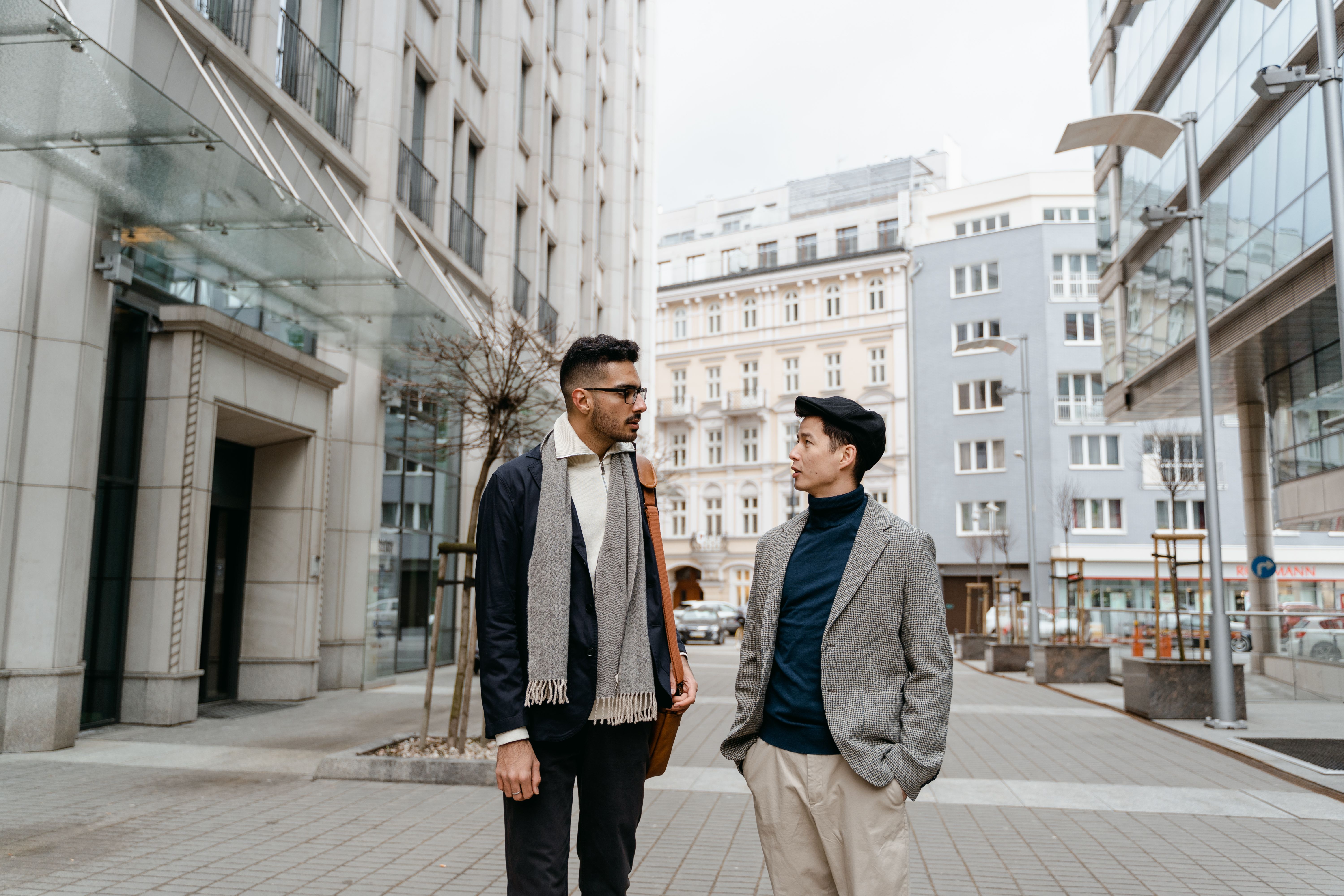 Two corporate professionals in premium business suits on city street