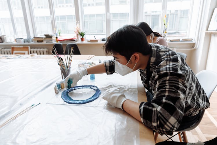 
A Man Pouring Resin On A Mold