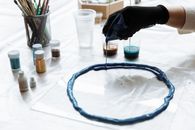 A Person Pouring Resin on a Mold
