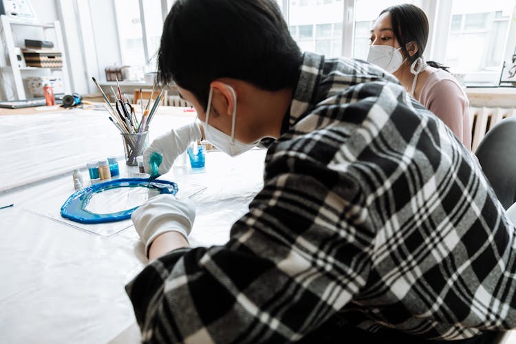 Man Pouring Paint Onto His Art Project