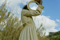 A Woman Holding a Mirror