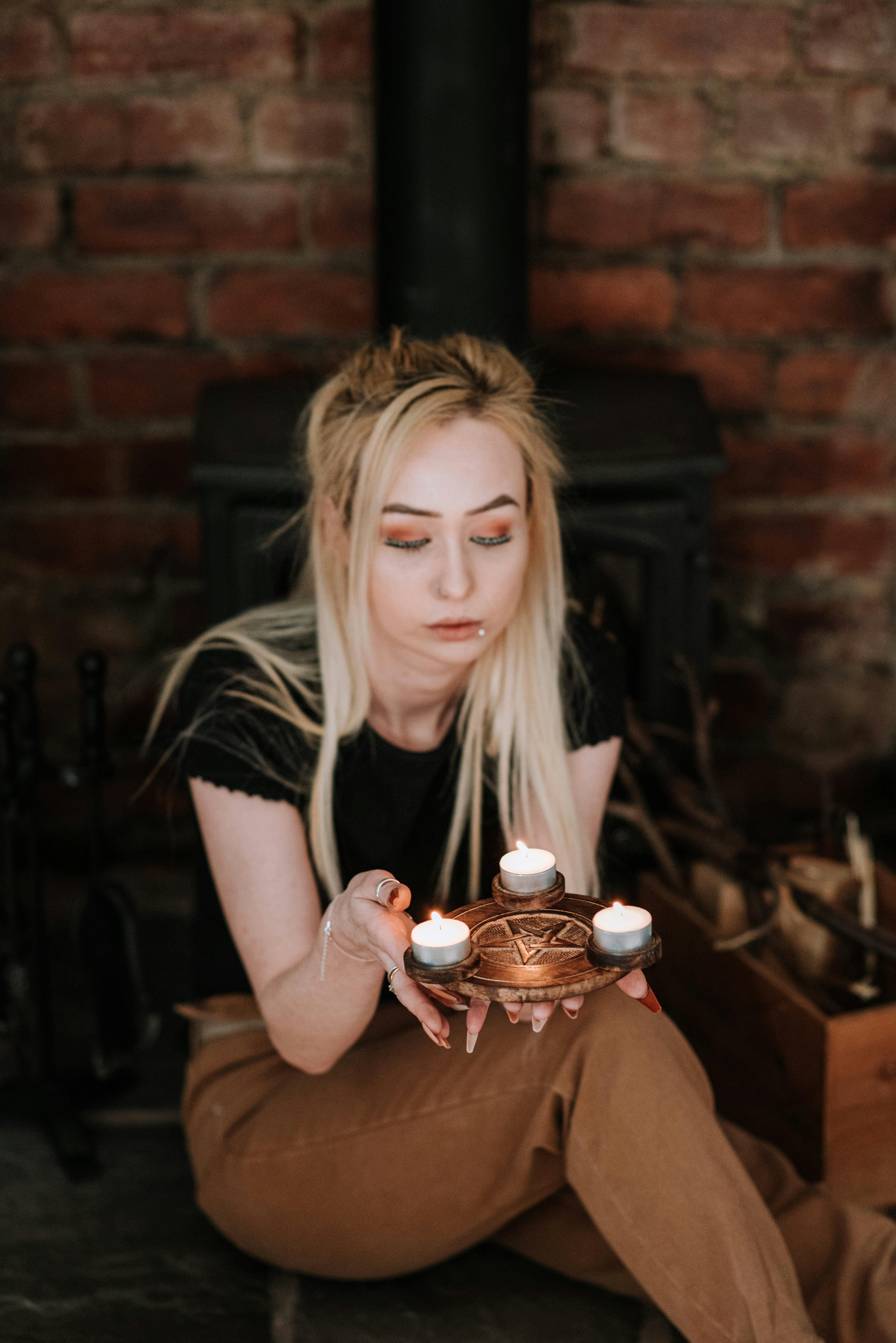 enigmatic woman with burning candles