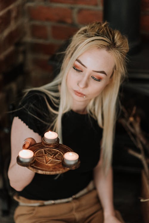 Woman with pentagram candle holder in hand