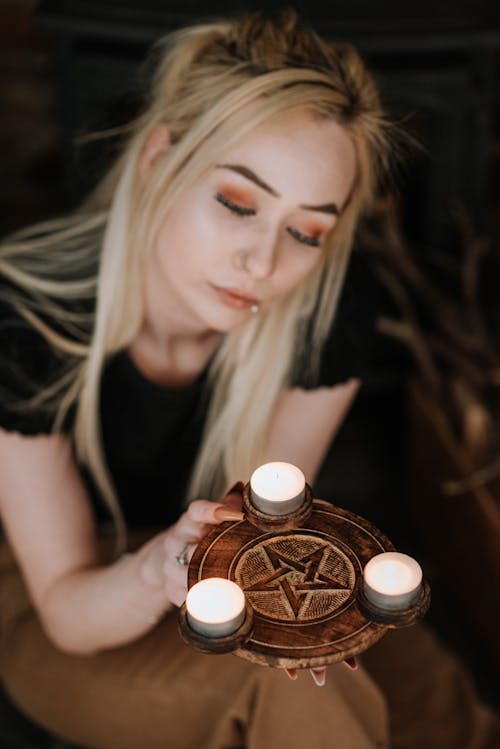 Enchantress with pentagram and shiny candles