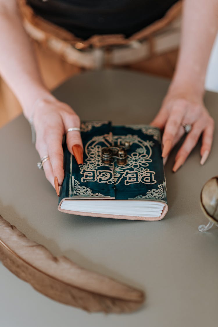 Woman With Vintage Notebook With Inscription Peace At Table