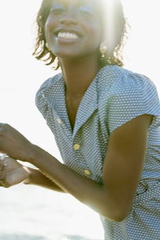 Joyful portrait of a woman basking in the sunlight, exuding happiness.