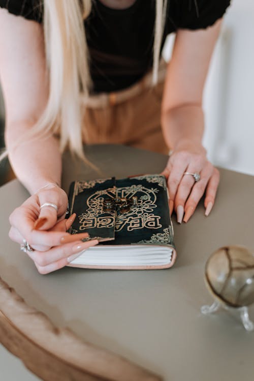 Soothsayer at table with thick notebook with word peace