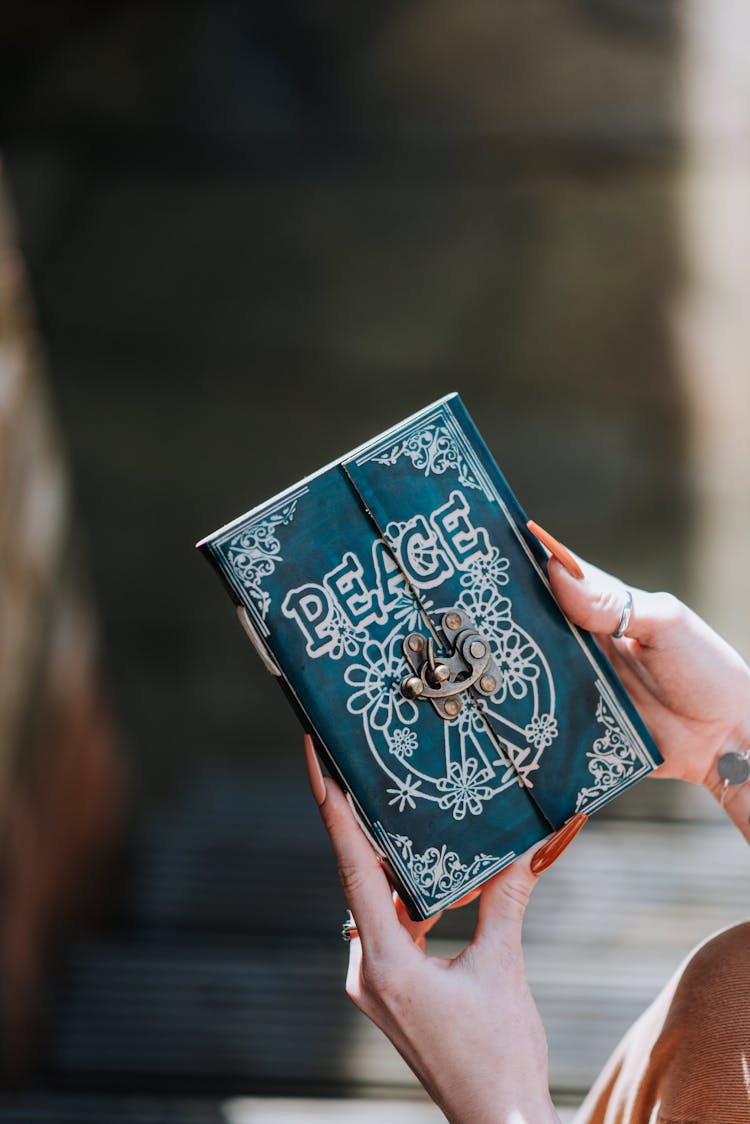 Woman With Vintage Notebook With Patterns And Word Peace