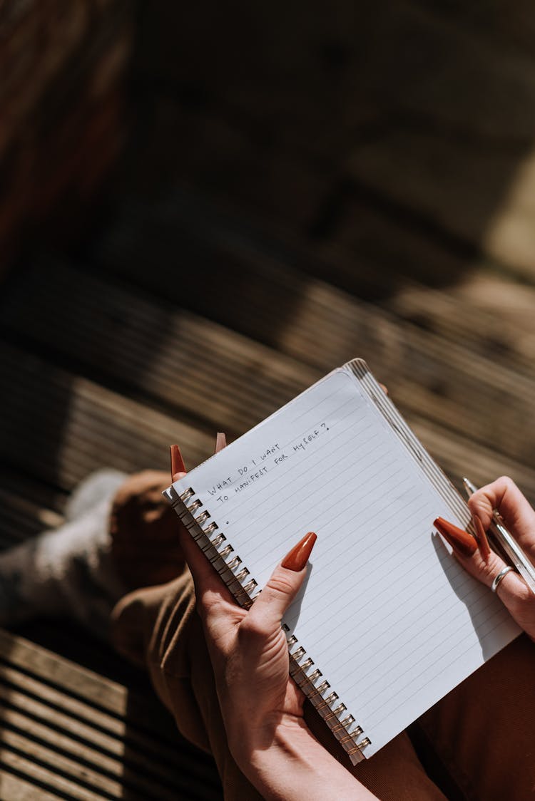 Woman Checking Text In Notebook In Daylight