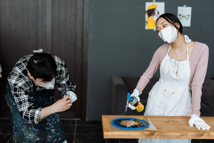 A Woman Using A Blowtorch 