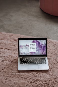 From above of netbook with desktop with motivation phrase at home in daytime
