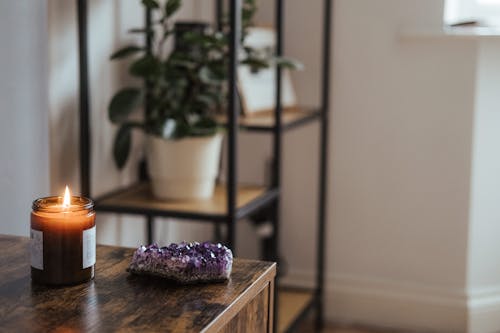 Amethyst near burning candle in room