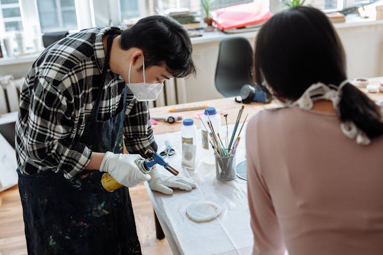 A Man And Woman Making Resin