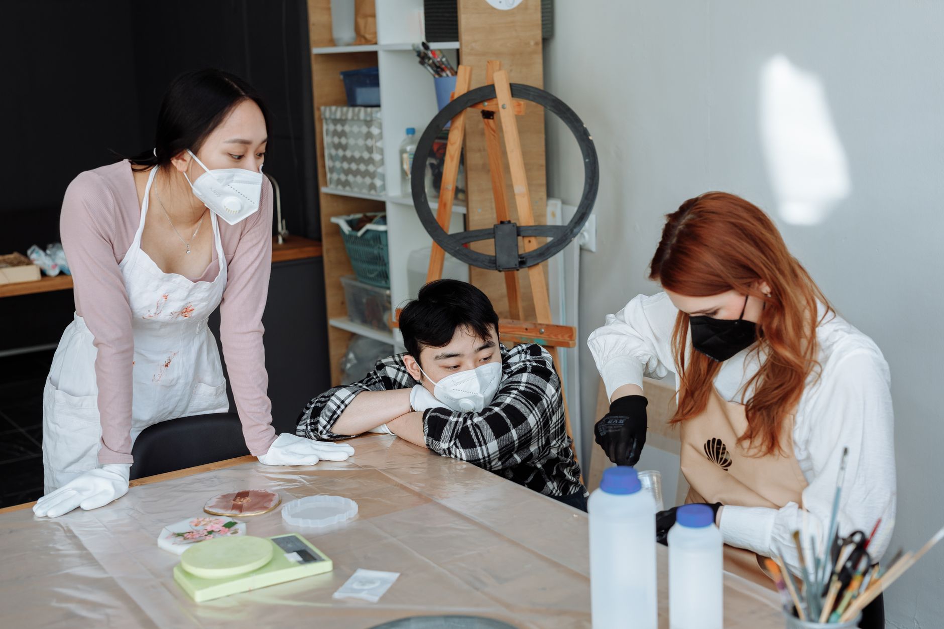 How to Share Tools Bought from Home Depot Safely A diverse group engaging in a creative workshop, wearing protective masks and gloves for safety.