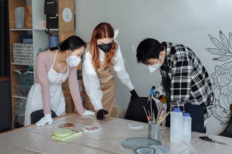 A Group Of People Making Resin