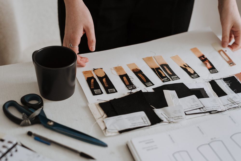 A flat lay of paint and fabric samples with drawings
