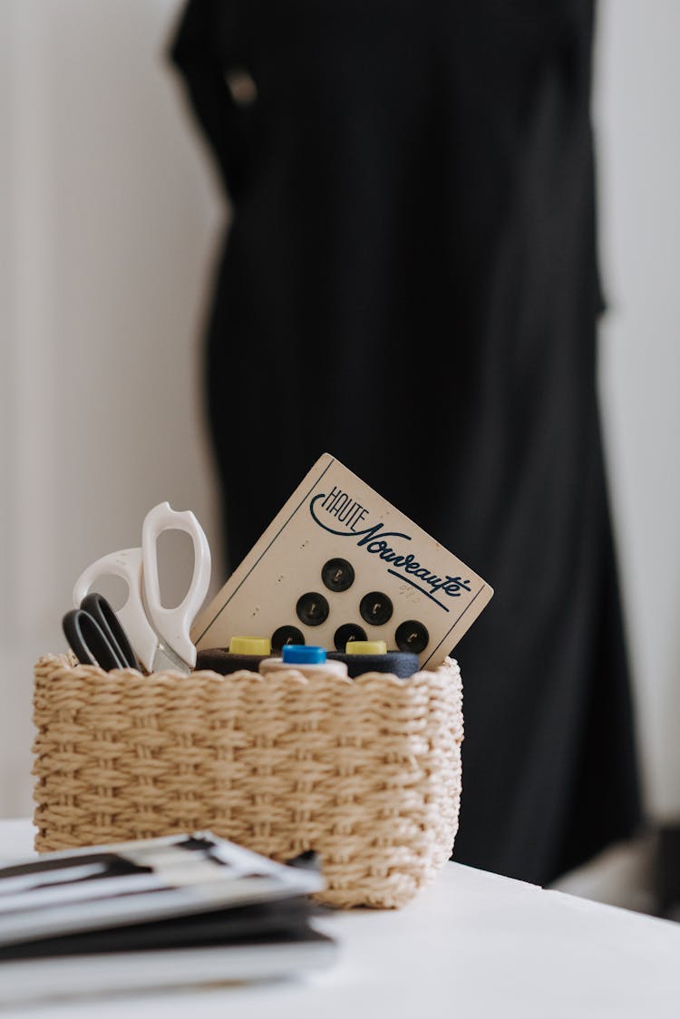 Sewing Supplies In Basket On Table