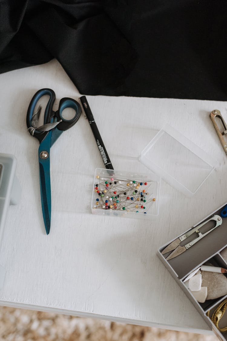 Sewing Pins With Scissors In Studio