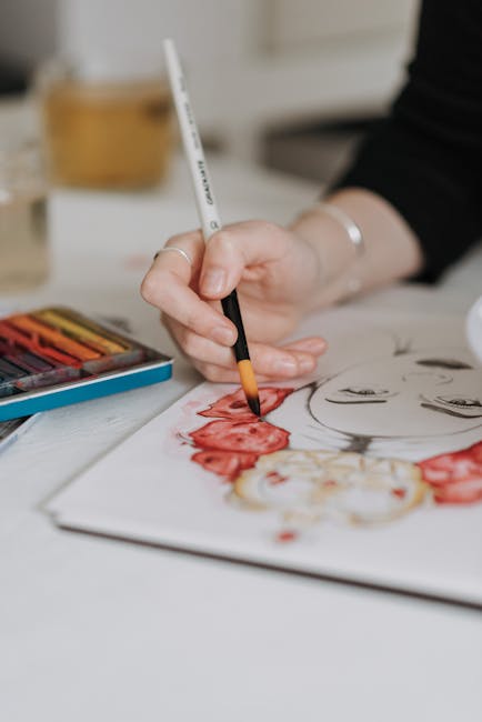 Close-up of hand painting with a brush in a watercolor artwork. Vibrant colors.