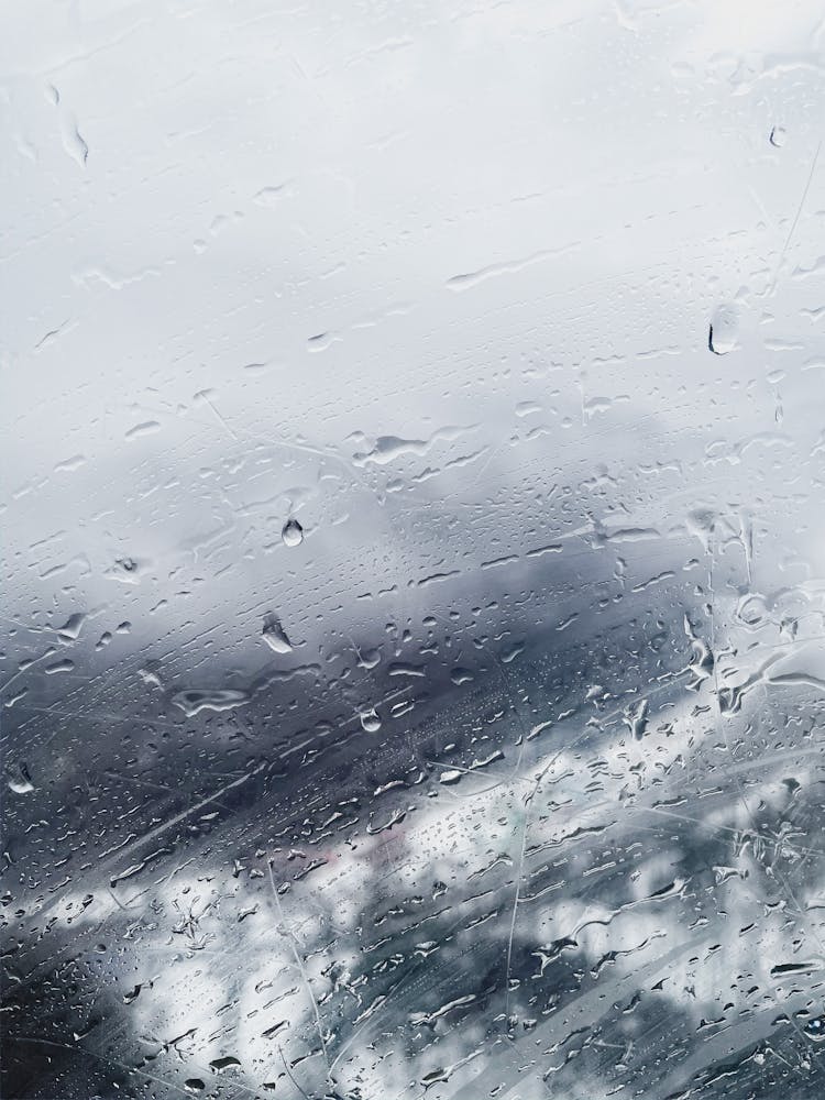 Snow In Forest Behind Wet Glass