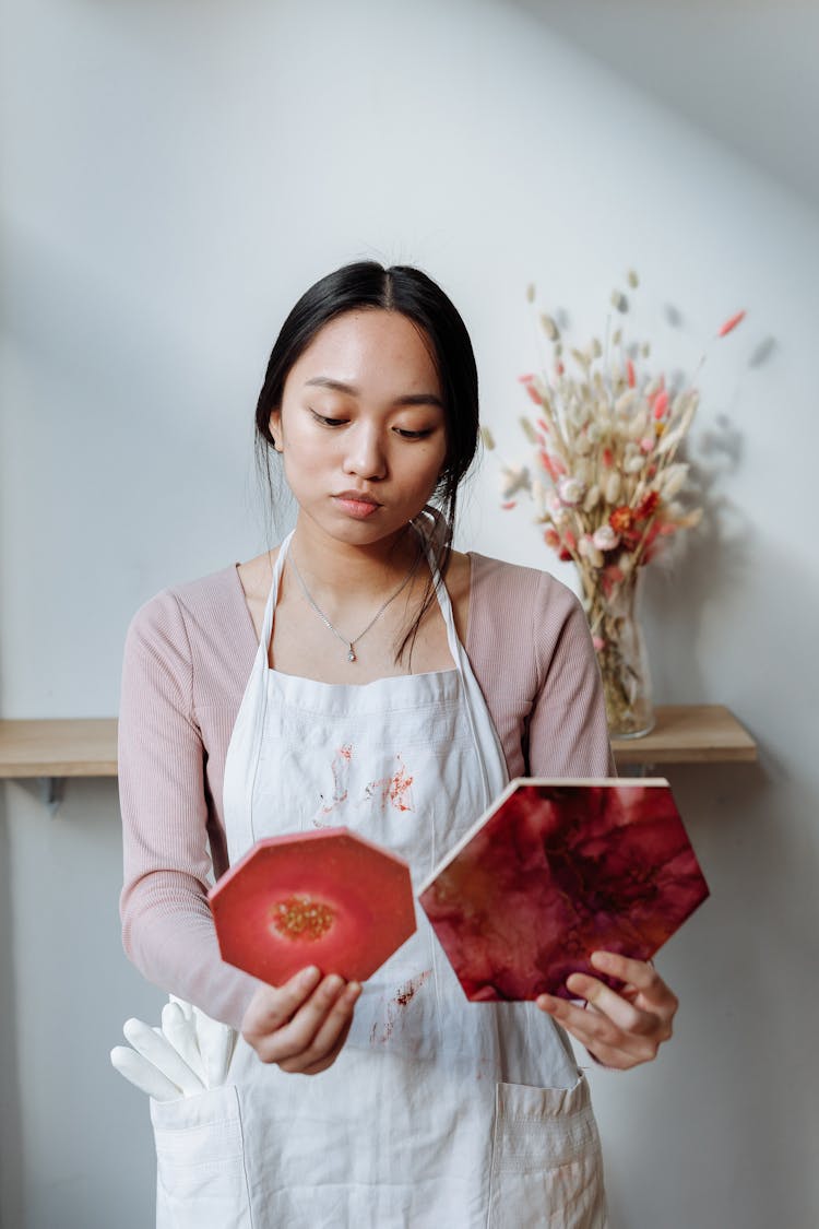 A Woman In White Apron Holding A Resin Art With Hexagon Shaped