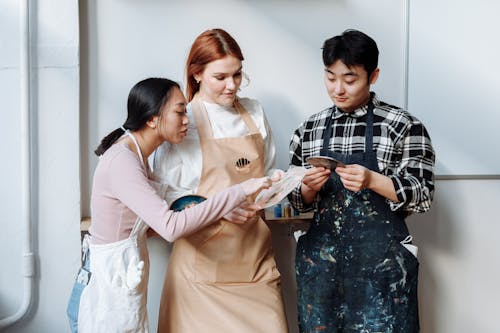 A Group of People Wearing Aprons while Having Conversation