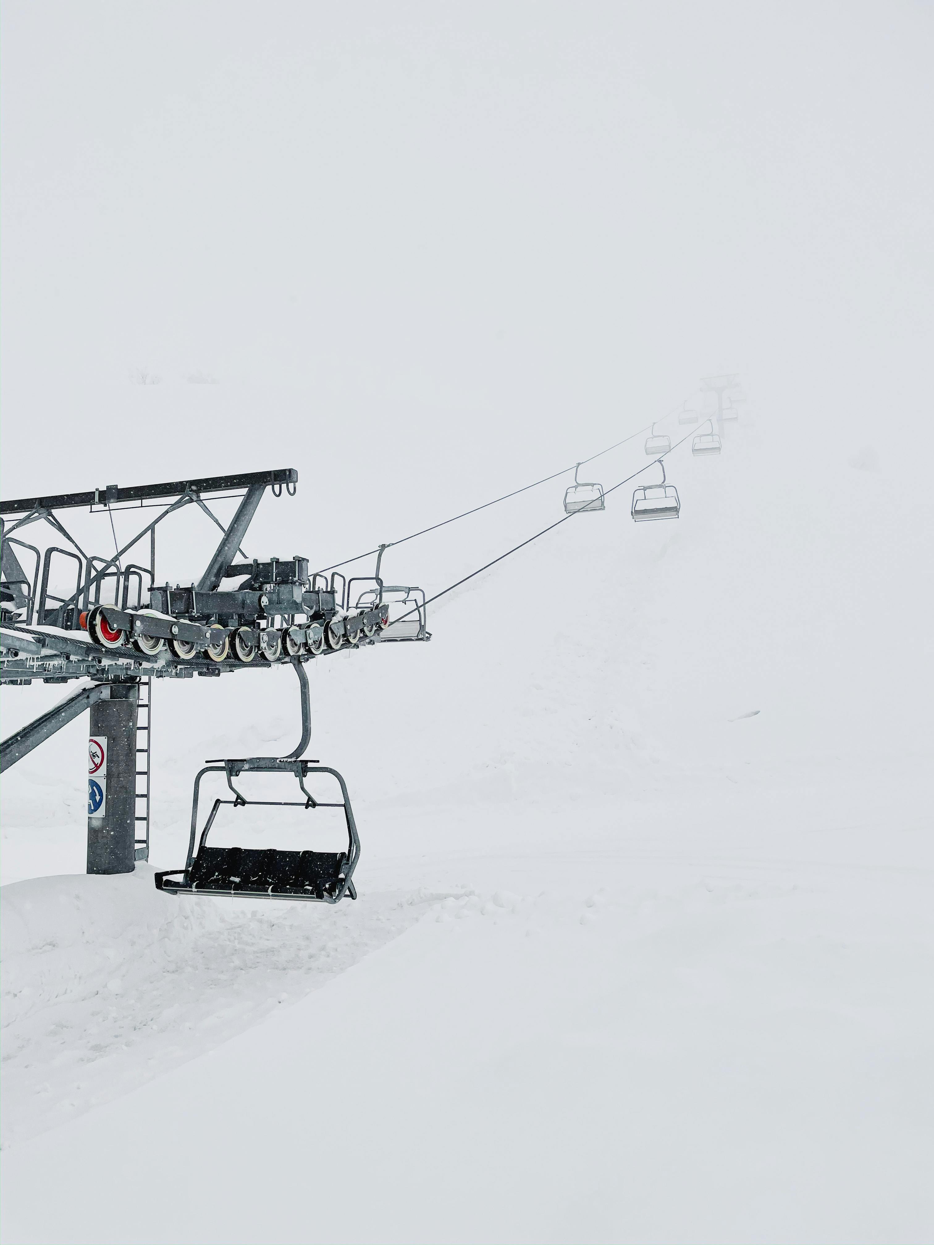 Prescription Goggle Inserts - Ski lift in a foggy snow-covered landscape, capturing the essence of winter sports.